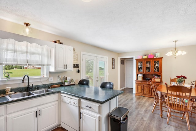 3970 Pleasant Grove Rd, White House, TN 37188 - kitchen with dishwasher, a sink, a peninsula, dark countertops, and a chandelier