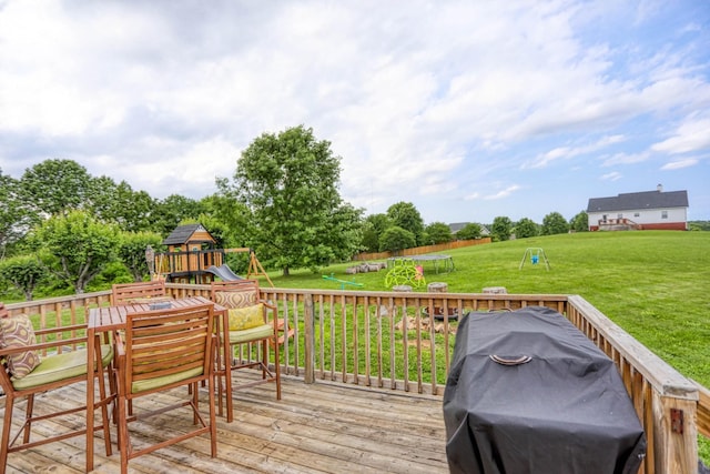 3970 Pleasant Grove Rd, White House, TN 37188 - wooden terrace featuring a trampoline, a playground, a grill, a lawn, and outdoor dining space