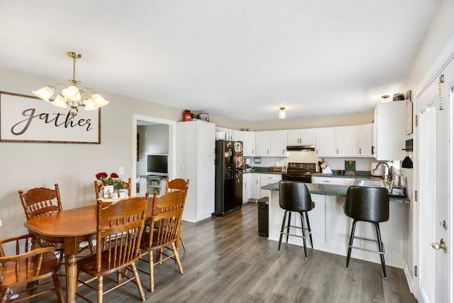 3970 Pleasant Grove Rd, White House, TN 37188 - dining area featuring a chandelier and dark wood-style flooring