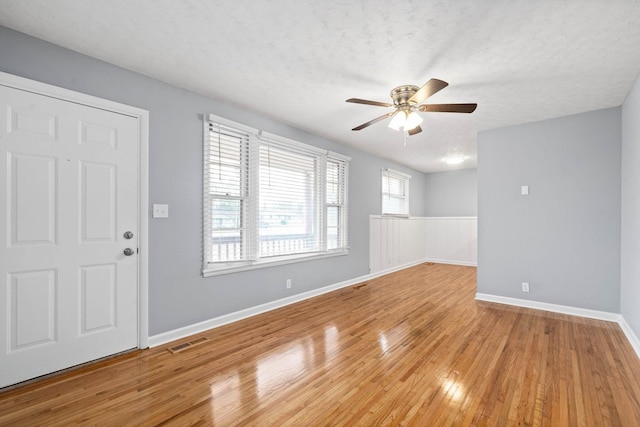 101 Charlemagne Blvd, Clarksville, TN 37042 - entrance foyer featuring light wood-style floors, ceiling fan, a textured ceiling, baseboards, and a wainscoted wall
