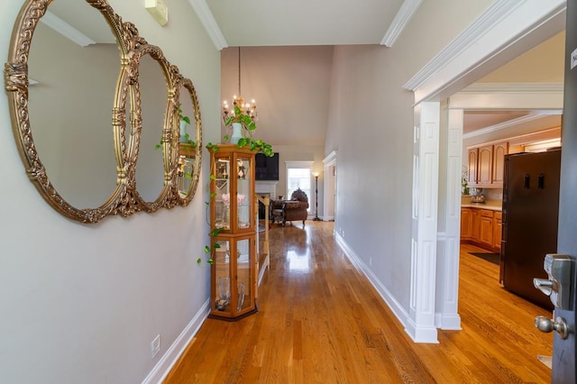 2317 Saint Andrews Dr, Murfreesboro, TN 37128 - hall with light wood-style flooring, a chandelier, baseboards, and ornamental molding