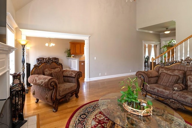 2317 Saint Andrews Dr, Murfreesboro, TN 37128 - living area with high vaulted ceiling, a chandelier, light wood-style flooring, stairs, and baseboards
