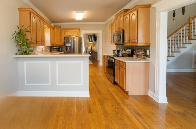 2317 Saint Andrews Dr, Murfreesboro, TN 37128 - kitchen with appliances with stainless steel finishes, light countertops, light wood-type flooring, tasteful backsplash, and ornamental molding
