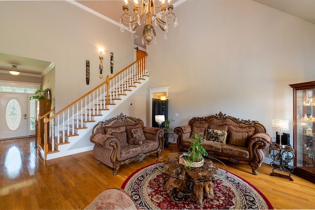 2317 Saint Andrews Dr, Murfreesboro, TN 37128 - living room featuring stairway, wood finished floors, a chandelier, ornamental molding, and a high ceiling