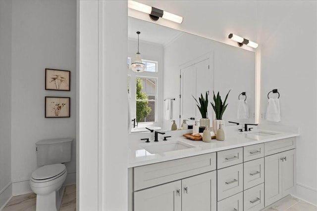 1709 Hillmont Dr, Nashville, TN 37215 - full bathroom featuring double vanity, toilet, baseboards, and ornamental molding