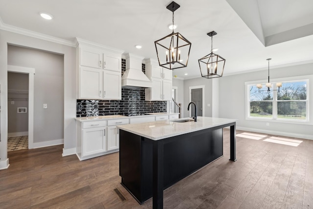 2200 Hamilton Chambers Rd, Lebanon, TN 37087 - kitchen featuring a sink, a chandelier, ornamental molding, custom exhaust hood, and baseboards
