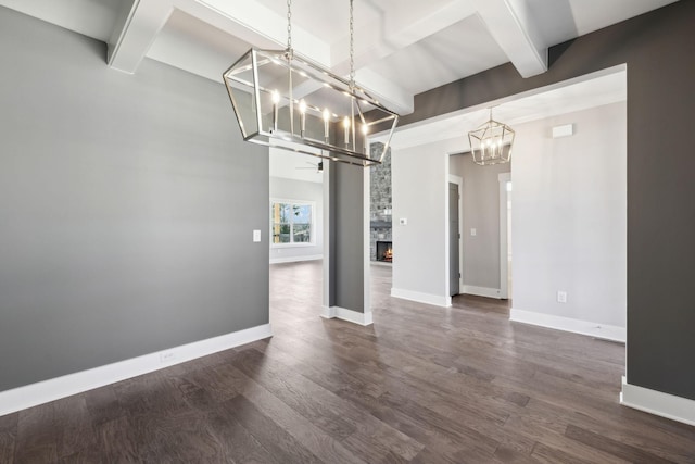 2200 Hamilton Chambers Rd, Lebanon, TN 37087 - empty room with a chandelier, beam ceiling, baseboards, dark wood finished floors, and a stone fireplace