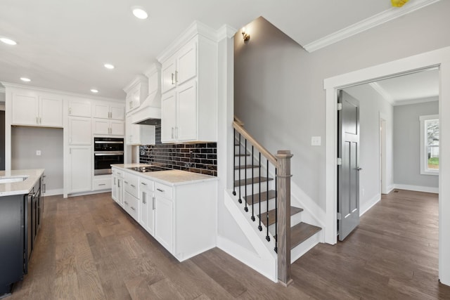 2200 Hamilton Chambers Rd, Lebanon, TN 37087 - kitchen with stainless steel double oven, crown molding, dark wood-style flooring, black electric stovetop, and light countertops