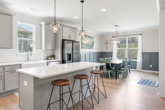 883 Plowson Rd, Mount Juliet, TN 37122 - kitchen with stainless steel fridge with ice dispenser, a sink, plenty of natural light, a breakfast bar, and crown molding