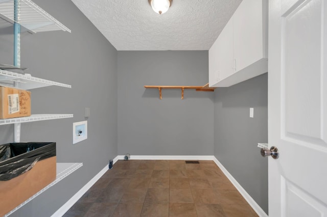 7108 Gregory Ct, Fairview, TN 37062 - laundry area with washer hookup, a textured ceiling, and baseboards