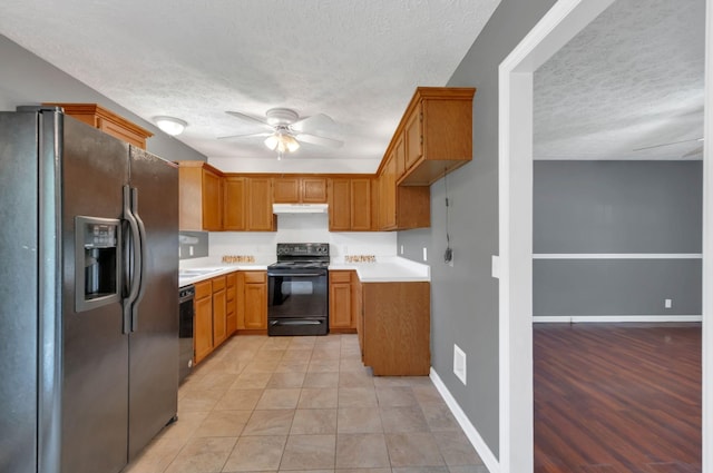 7108 Gregory Ct, Fairview, TN 37062 - kitchen featuring black appliances, a textured ceiling, ceiling fan, light countertops, and brown cabinetry