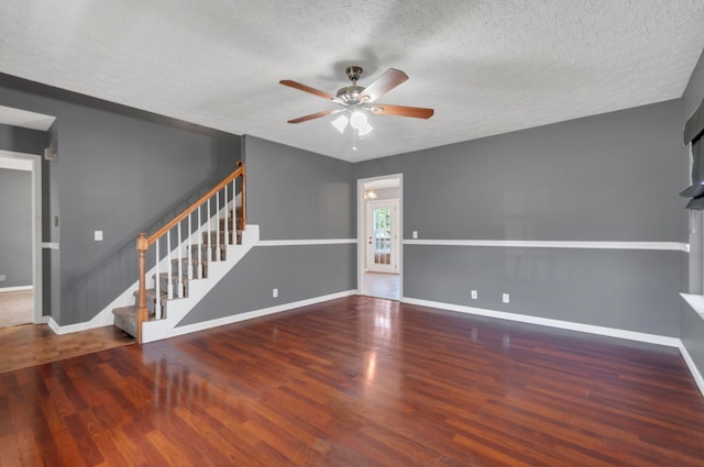 7108 Gregory Ct, Fairview, TN 37062 - unfurnished living room with ceiling fan, a textured ceiling, stairs, baseboards, and wood finished floors