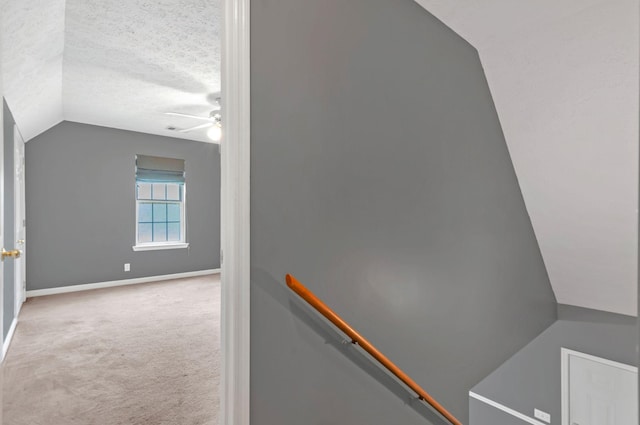 7108 Gregory Ct, Fairview, TN 37062 - stairway featuring lofted ceiling, ceiling fan, carpet floors, baseboards, and a textured ceiling