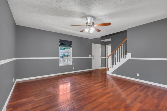 7108 Gregory Ct, Fairview, TN 37062 - unfurnished room featuring a ceiling fan, stairs, baseboards, a textured ceiling, and wood finished floors