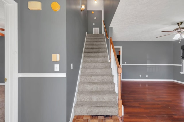 7108 Gregory Ct, Fairview, TN 37062 - staircase featuring ceiling fan, baseboards, a textured ceiling, and wood finished floors