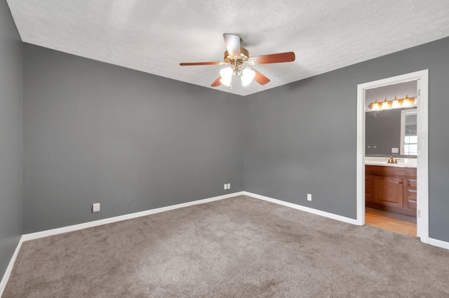 7108 Gregory Ct, Fairview, TN 37062 - carpeted empty room featuring ceiling fan, a textured ceiling, baseboards, and a sink