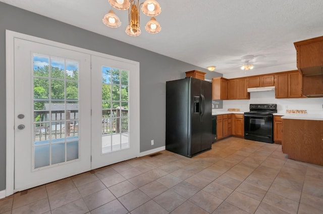 7108 Gregory Ct, Fairview, TN 37062 - kitchen with black appliances, under cabinet range hood, light countertops, ceiling fan, and a chandelier