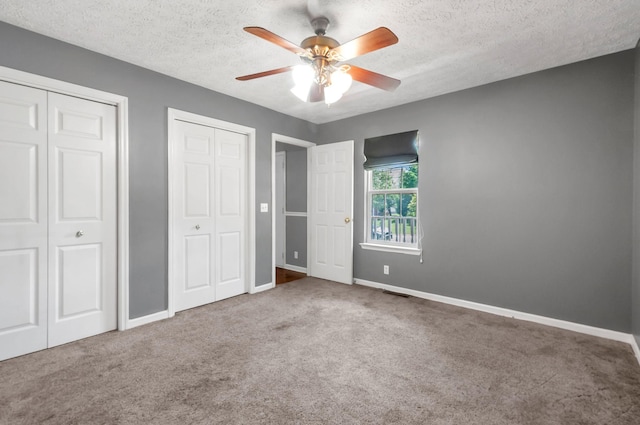 7108 Gregory Ct, Fairview, TN 37062 - unfurnished bedroom with two closets, carpet floors, baseboards, a textured ceiling, and a ceiling fan