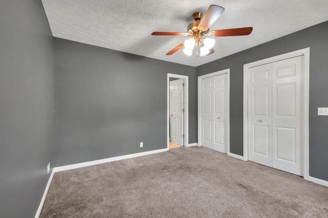 7108 Gregory Ct, Fairview, TN 37062 - unfurnished bedroom with two closets, baseboards, carpet floors, a textured ceiling, and ceiling fan