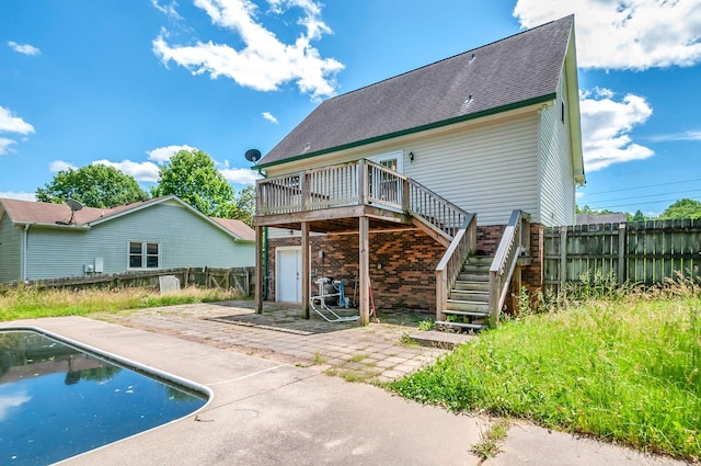7108 Gregory Ct, Fairview, TN 37062 - rear view of property with stairway, a deck, a patio area, a fenced backyard, and roof with shingles