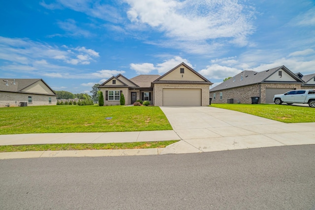 82 Pinnacle Point Ln, Tullahoma, TN 37388 - view of front of home featuring brick siding, a garage, a front yard, concrete driveway, and central AC unit