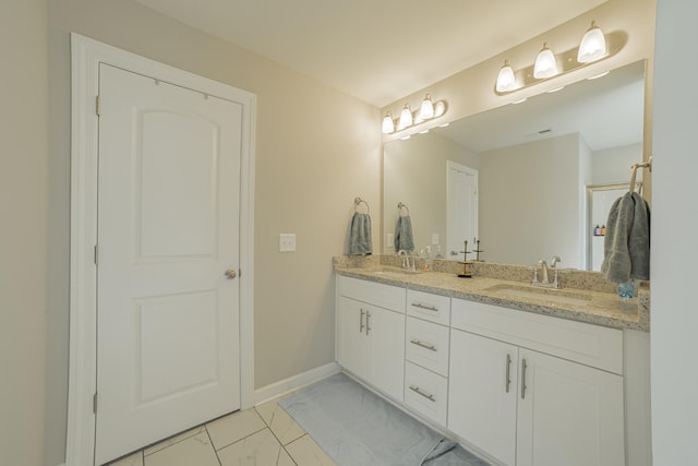 82 Pinnacle Point Ln, Tullahoma, TN 37388 - bathroom with marble look tiles, double vanity, and baseboards