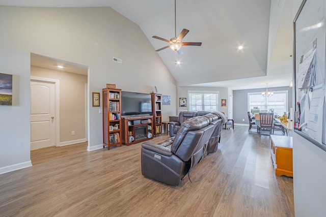 82 Pinnacle Point Ln, Tullahoma, TN 37388 - living room featuring high vaulted ceiling, a ceiling fan, a chandelier, baseboards, and light wood-style floors