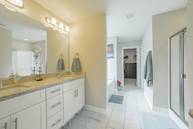 82 Pinnacle Point Ln, Tullahoma, TN 37388 - bathroom with a stall shower, baseboards, double vanity, marble look tiles, and a garden tub