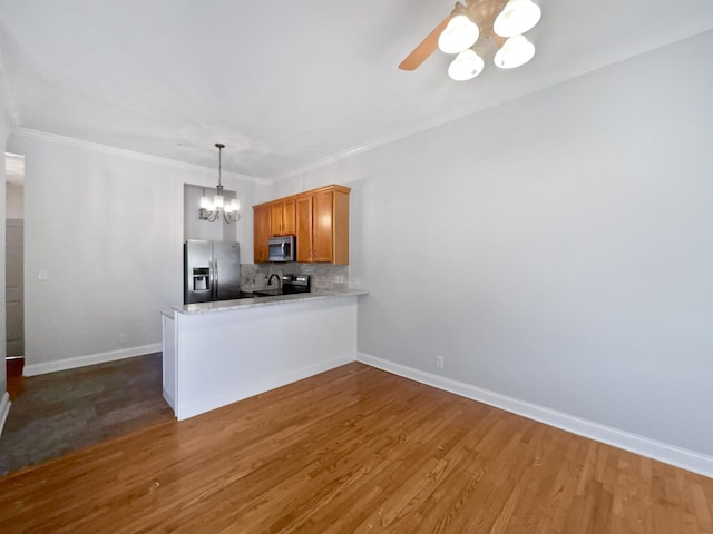 137 Dean St, Pleasant View, TN 37146 - kitchen with stainless steel appliances, a chandelier, backsplash, dark wood-style floors, and a peninsula