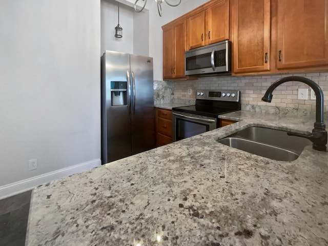 137 Dean St, Pleasant View, TN 37146 - kitchen featuring stainless steel appliances, a sink, tasteful backsplash, and brown cabinetry