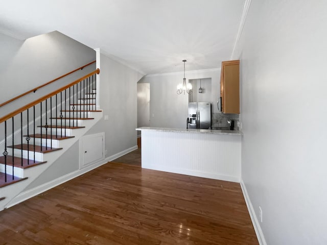 137 Dean St, Pleasant View, TN 37146 - kitchen featuring stainless steel refrigerator with ice dispenser, dark wood-style flooring, ornamental molding, a chandelier, and a peninsula