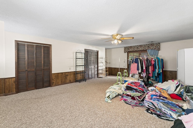 191 Green Harbor Rd, Old Hickory, TN 37138 - bedroom featuring a wainscoted wall, wooden walls, carpet floors, a textured ceiling, and ceiling fan