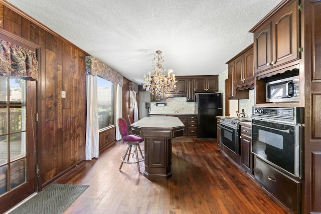 191 Green Harbor Rd, Old Hickory, TN 37138 - kitchen featuring black appliances, a kitchen island, a chandelier, backsplash, and dark wood-type flooring