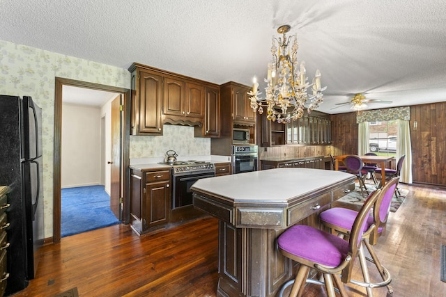 191 Green Harbor Rd, Old Hickory, TN 37138 - kitchen with wallpapered walls, appliances with stainless steel finishes, a textured ceiling, light countertops, and dark wood finished floors