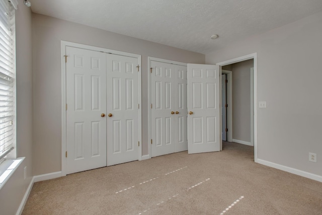 5409 Oak Chase Dr, Antioch, TN 37013 - unfurnished bedroom with multiple closets, carpet floors, and baseboards