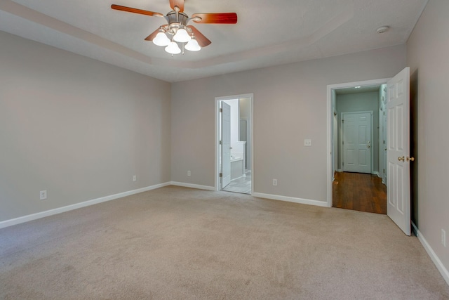 5409 Oak Chase Dr, Antioch, TN 37013 - unfurnished bedroom with carpet flooring, baseboards, connected bathroom, a raised ceiling, and a ceiling fan