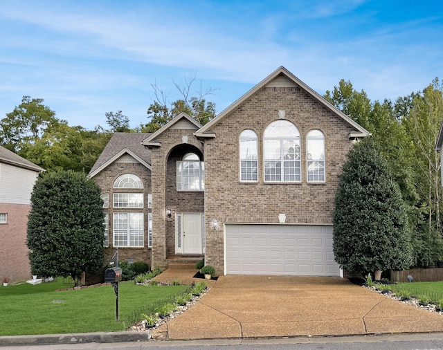 5409 Oak Chase Dr, Antioch, TN 37013 - view of front of house with concrete driveway, an attached garage, brick siding, and a front yard