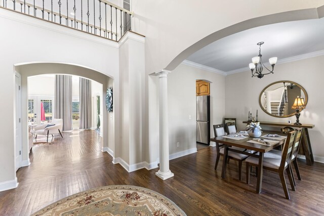 1408 Baker Ln, Lawrenceburg, TN 38464 - dining space featuring arched walkways, baseboards, ornamental molding, dark wood-type flooring, and a chandelier