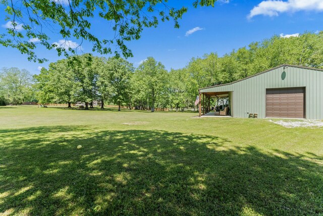 1408 Baker Ln, Lawrenceburg, TN 38464 - view of green lawn with a detached garage and an outbuilding