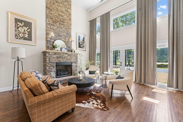 1408 Baker Ln, Lawrenceburg, TN 38464 - living room featuring a towering ceiling, dark wood finished floors, healthy amount of natural light, and a stone fireplace