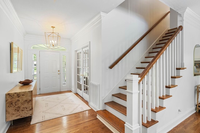 2974 W Mor Dr, Clarksville, TN 37043 - entryway featuring stairway, wood finished floors, crown molding, a chandelier, and baseboards