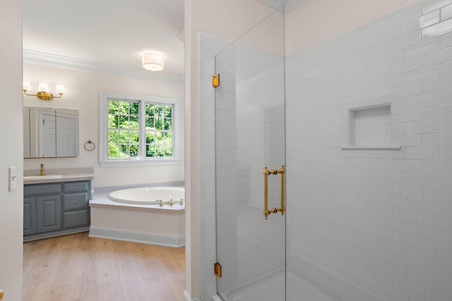 2974 W Mor Dr, Clarksville, TN 37043 - full bath featuring crown molding, vanity, a stall shower, a garden tub, and wood finished floors