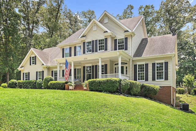 2974 W Mor Dr, Clarksville, TN 37043 - colonial-style house featuring covered porch, a shingled roof, and a front lawn