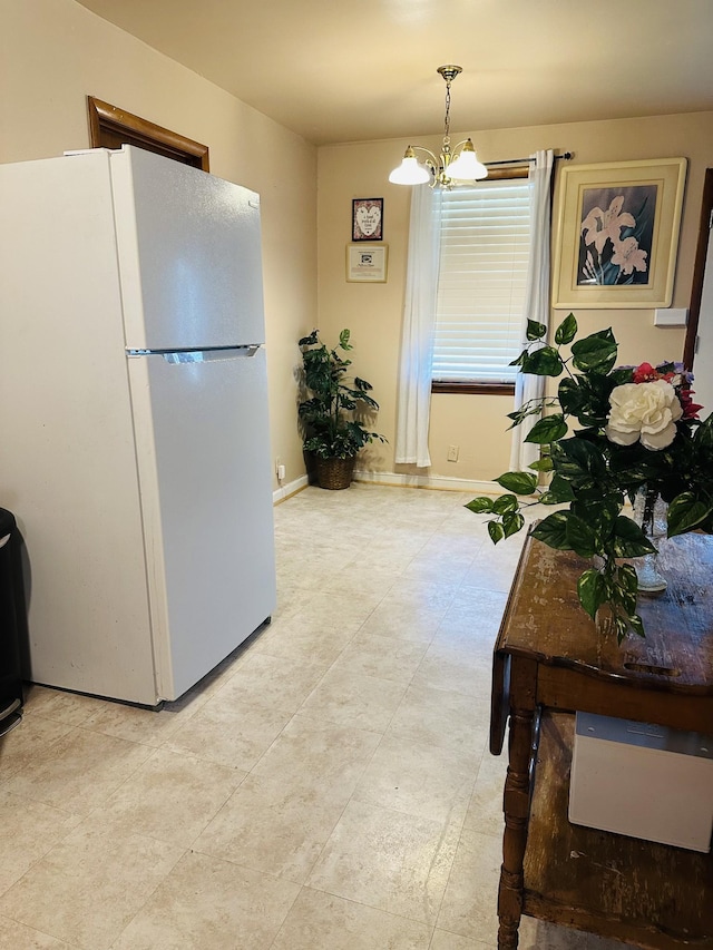 915 Wedgewood Ave, Nashville, TN 37203 - kitchen featuring freestanding refrigerator, a chandelier, and baseboards