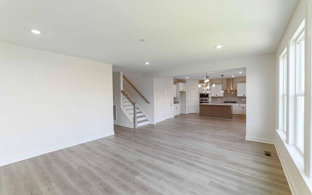 198 John T Alexander Blvd, Hendersonville, TN 37075 - unfurnished living room with stairs, light wood-style floors, baseboards, recessed lighting, and plenty of natural light