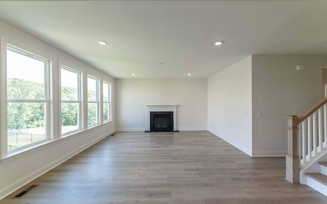 198 John T Alexander Blvd, Hendersonville, TN 37075 - unfurnished living room featuring recessed lighting, a fireplace with flush hearth, light wood-style floors, and baseboards