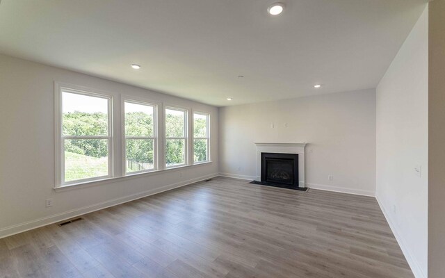 198 John T Alexander Blvd, Hendersonville, TN 37075 - unfurnished living room featuring wood finished floors, baseboards, a fireplace with flush hearth, and recessed lighting