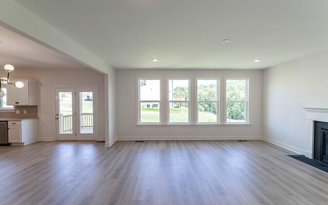 198 John T Alexander Blvd, Hendersonville, TN 37075 - unfurnished living room featuring light wood-style flooring, baseboards, a fireplace with flush hearth, a chandelier, and recessed lighting