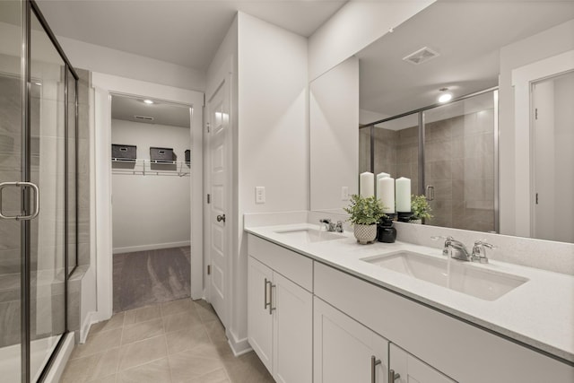 7212 Hanworth St, Fairview, TN 37062 - bathroom with a stall shower, double vanity, tile patterned floors, and a walk in closet
