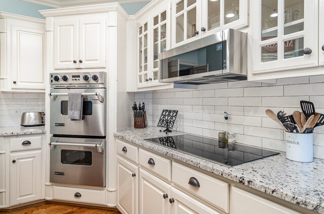 256 Scenic Dr, Dickson, TN 37055 - kitchen featuring appliances with stainless steel finishes, tasteful backsplash, white cabinets, and light stone countertops